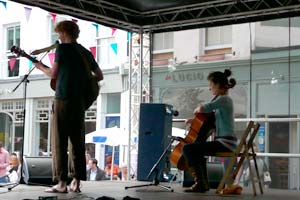 Violinist and cellist on stage at street festival